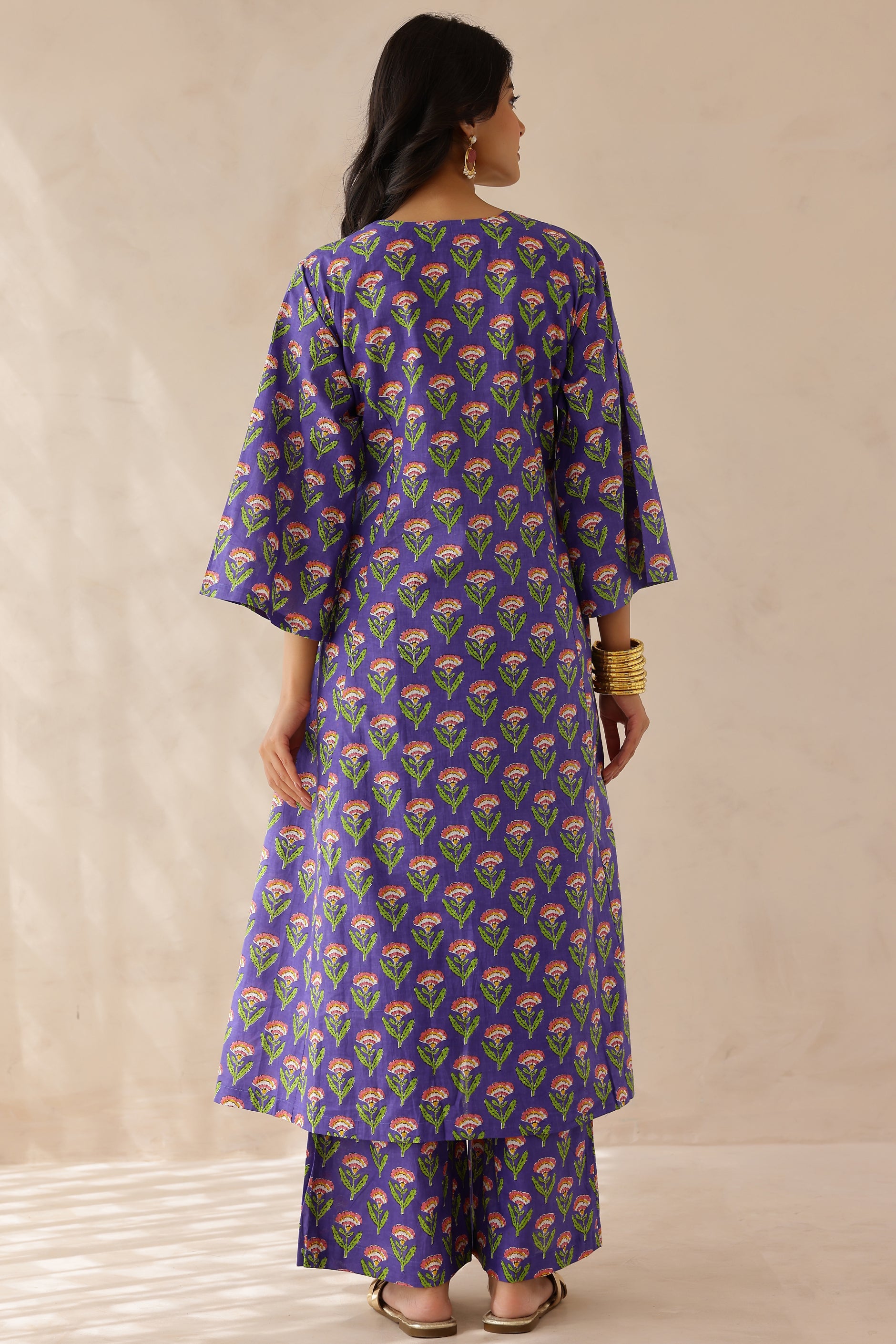 Woman wearing a purple floral patterned kurta 