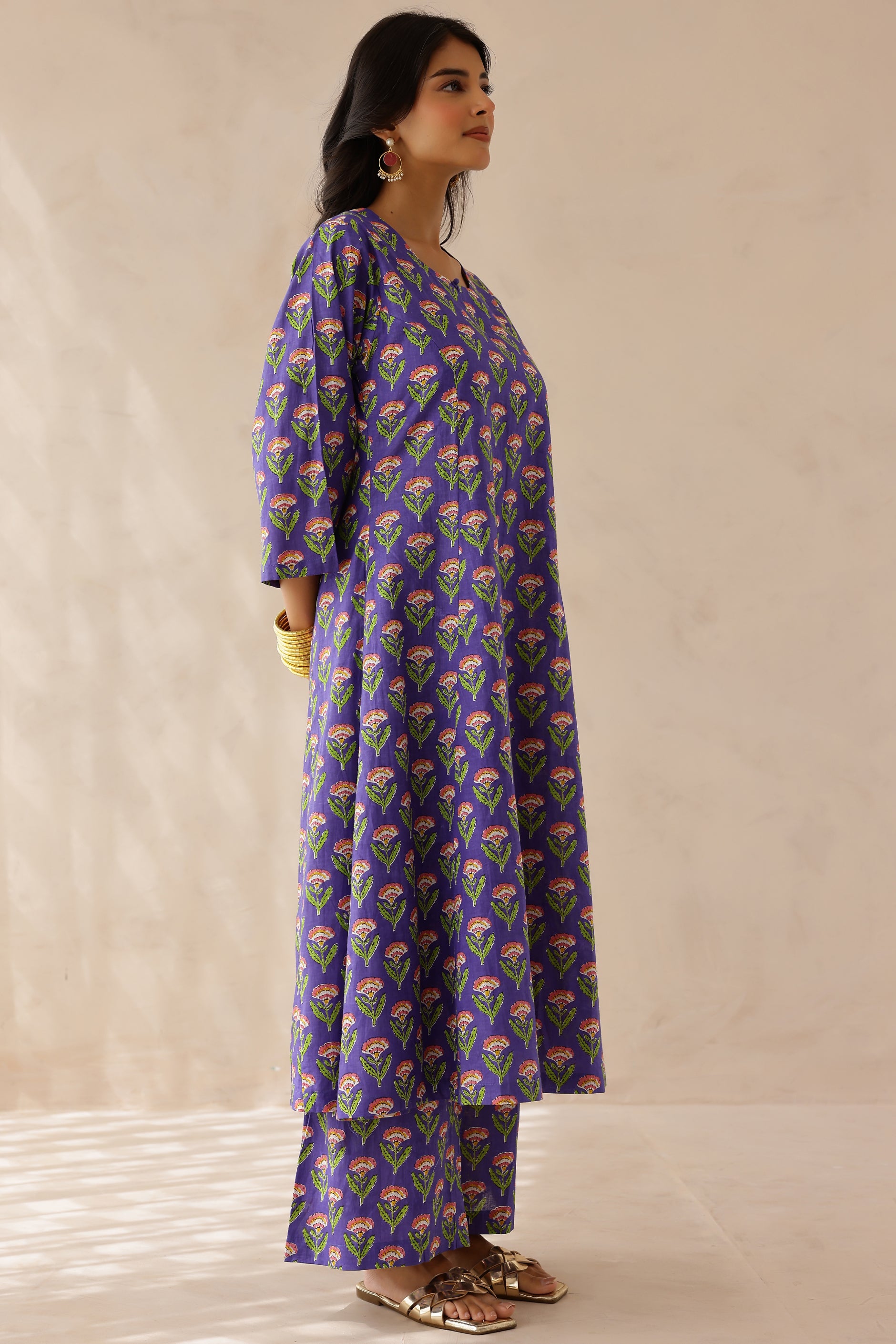 Woman wearing a purple floral patterned kurta 