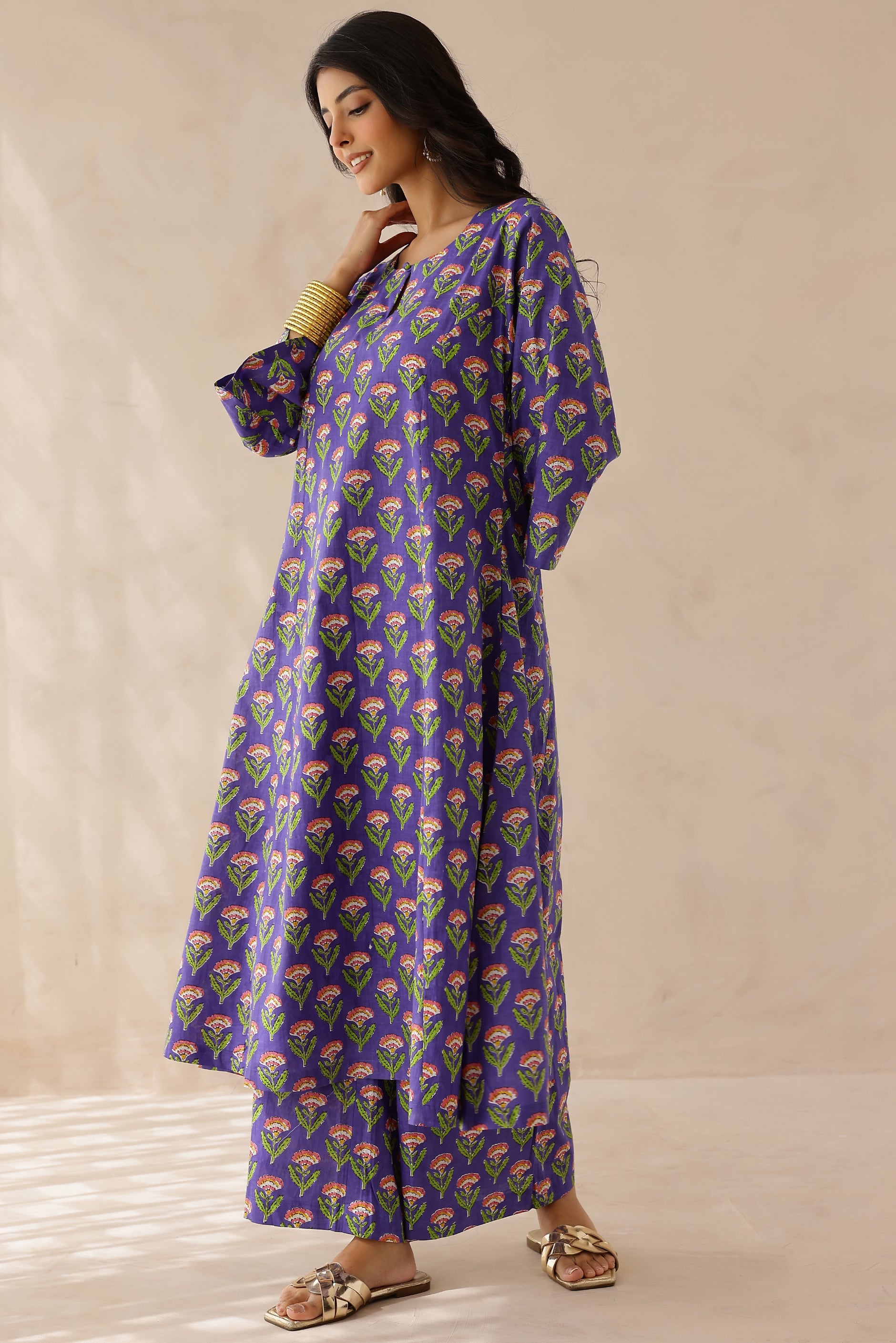 Woman wearing a purple floral patterned kurta 