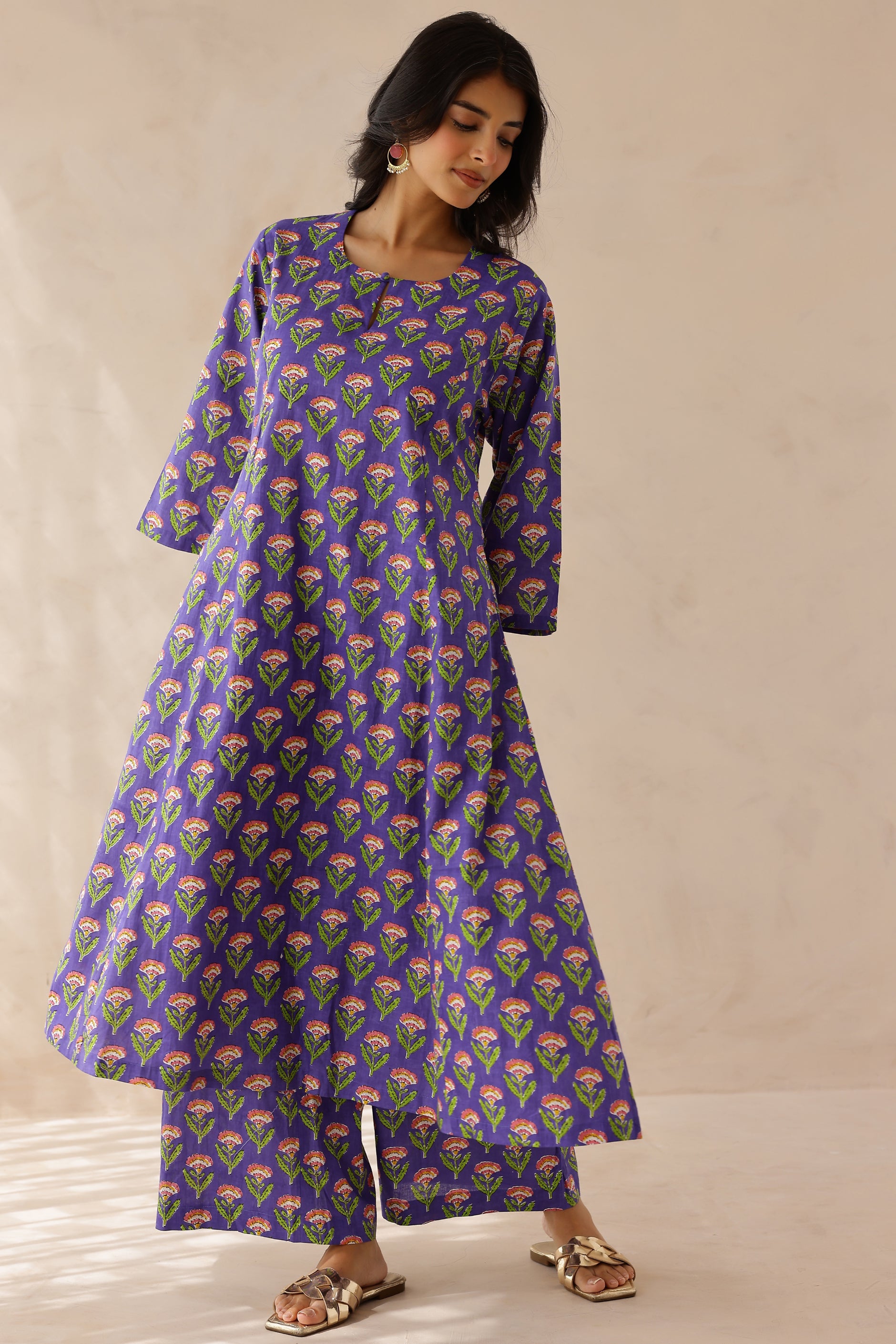 Woman wearing a purple floral patterned kurta 
