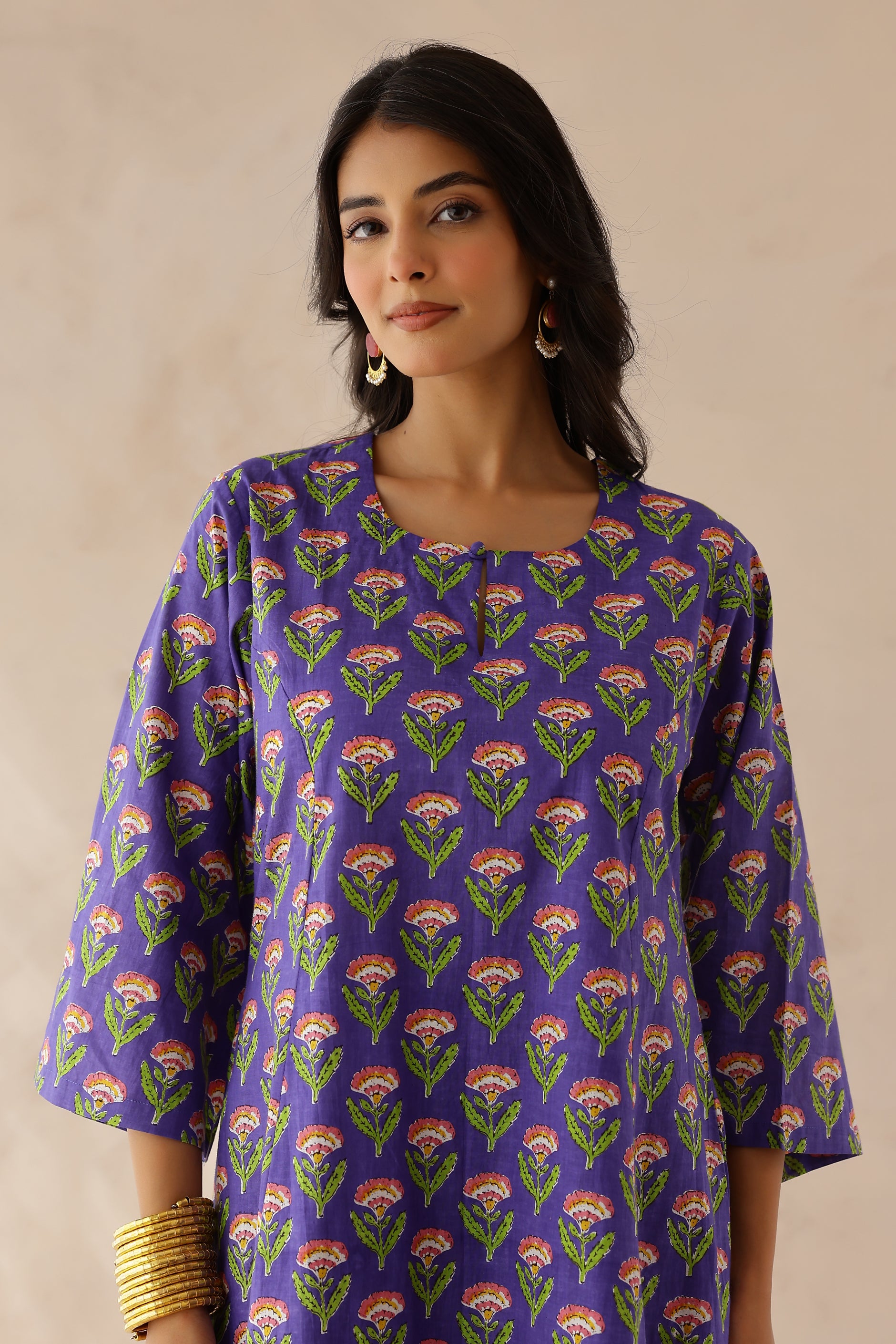 Woman wearing a purple floral patterned kurta 