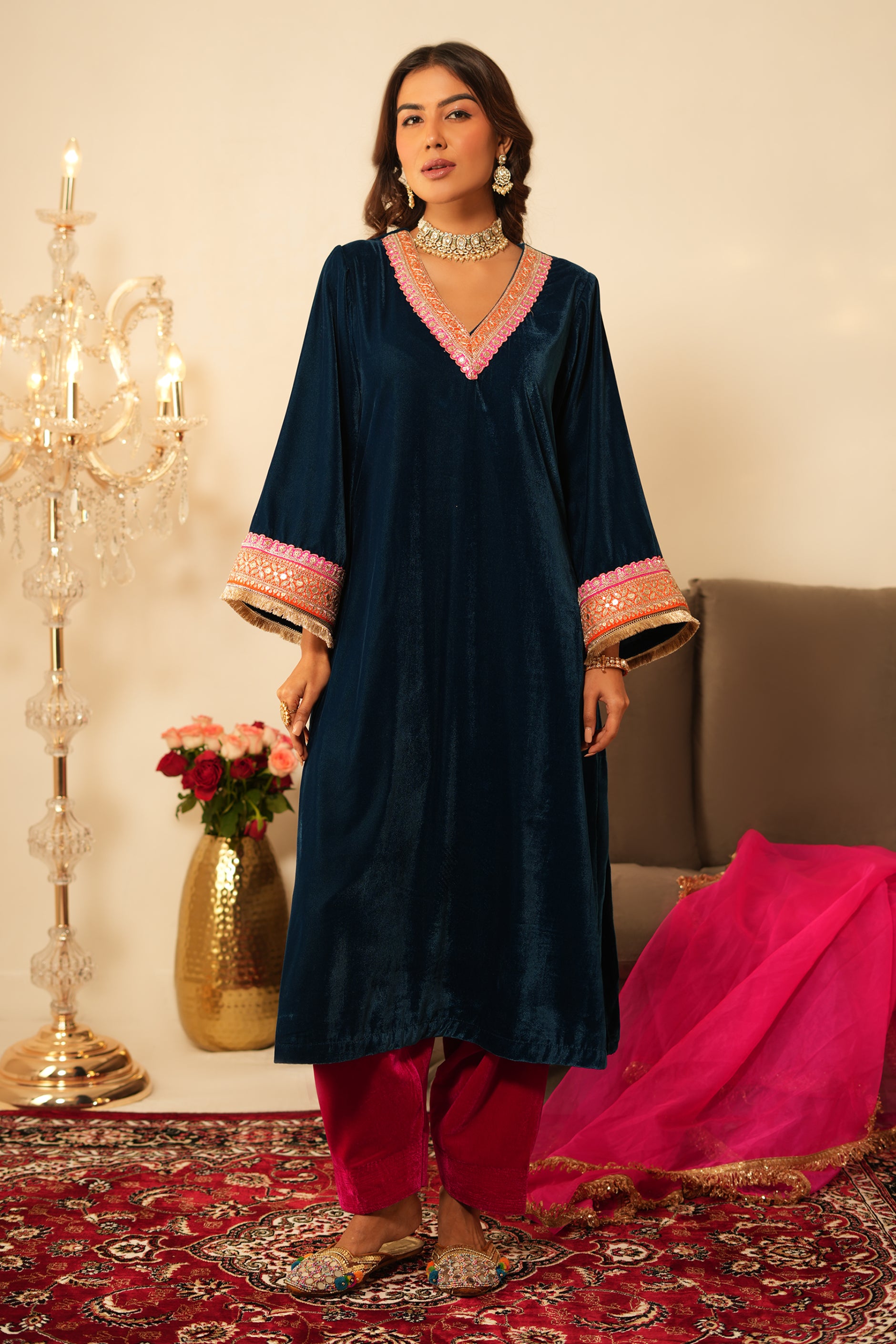 Woman wearing Blue Velvet Kurta with Pink Velvet Salwar Set of 2 featuring gota lace detailing, notched round neckline, full sleeves, and matching pink velvet salwar 