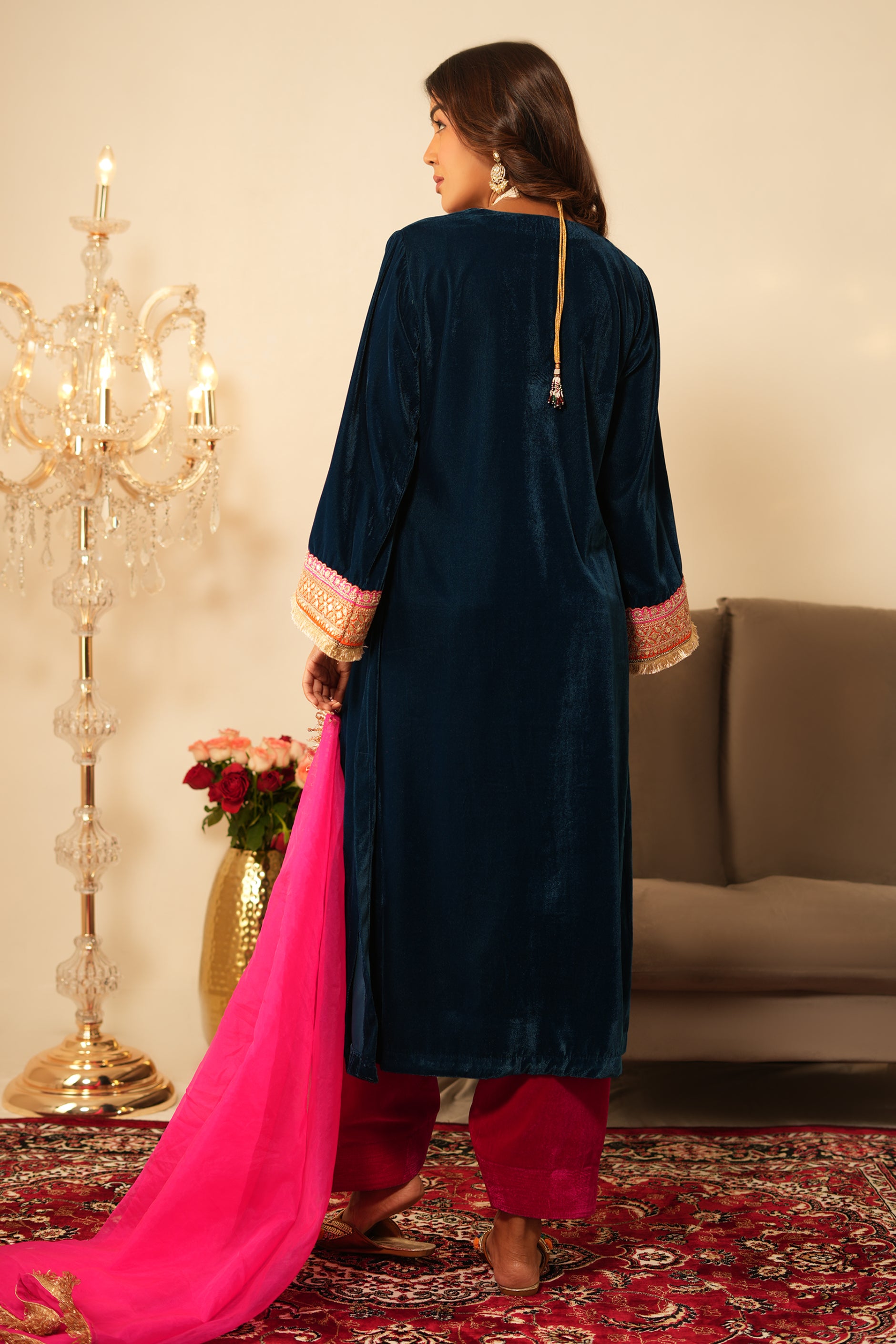 Woman wearing Blue Velvet Kurta with Pink Velvet Salwar Set of 2 featuring gota lace detailing, notched round neckline, full sleeves, and matching pink velvet salwar 