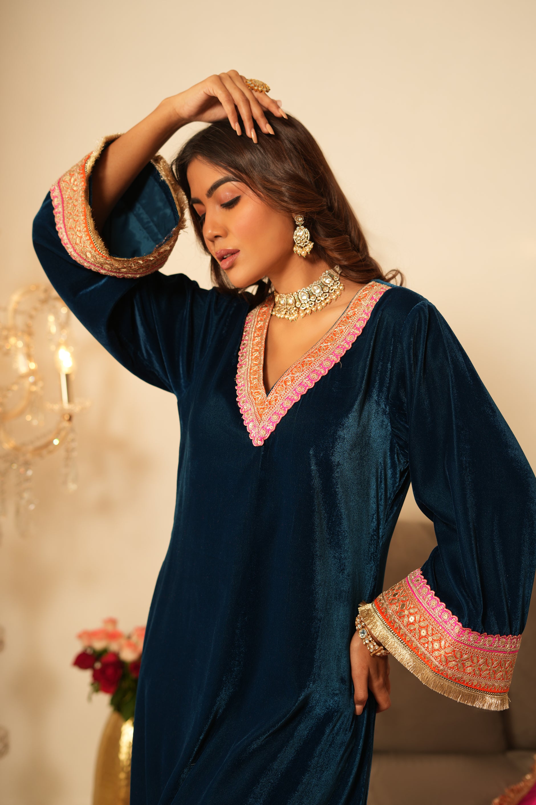 Woman wearing Blue Velvet Kurta with Pink Velvet Salwar Set of 2 featuring gota lace detailing, notched round neckline, full sleeves, and matching pink velvet salwar 