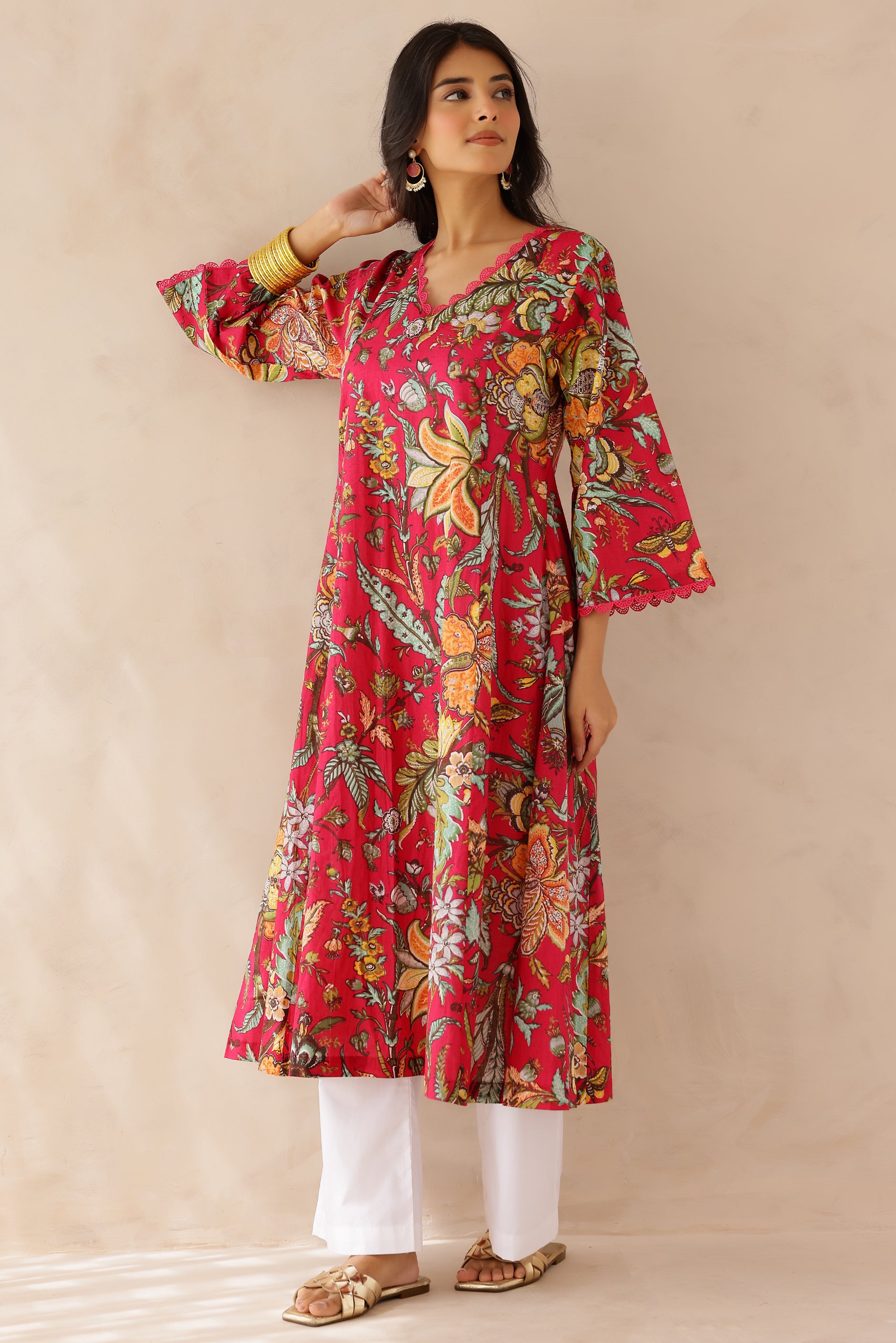 Woman wearing Multicolor Printed Cotton Kurta with Palazzo Set of 2 featuring all over multicolor prints, round to V neckline, 3/4th sleeves, and matching printed palazzo 