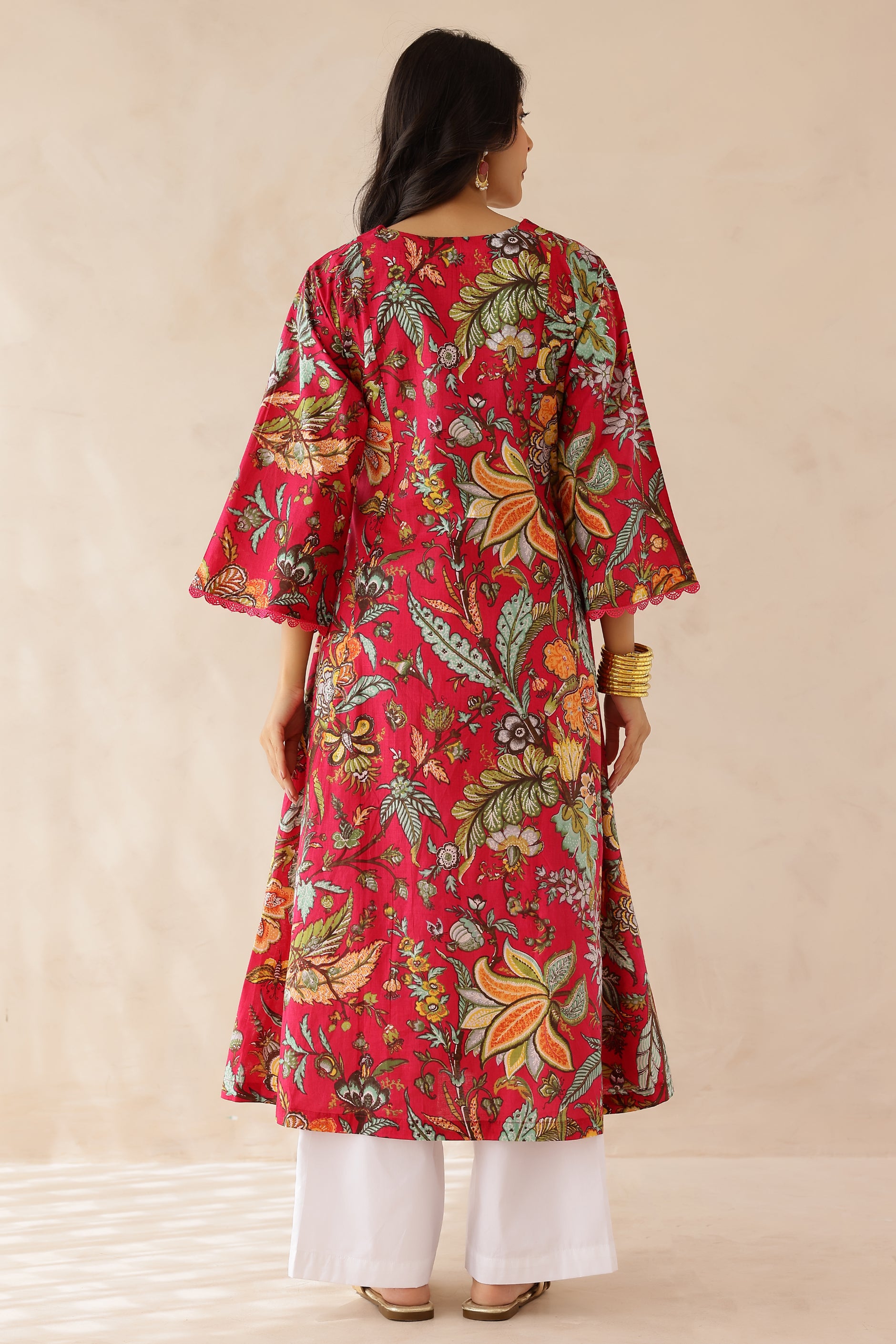 Woman wearing Multicolor Printed Cotton Kurta with Palazzo Set of 2 featuring all over multicolor prints, round to V neckline, 3/4th sleeves, and matching printed palazzo 