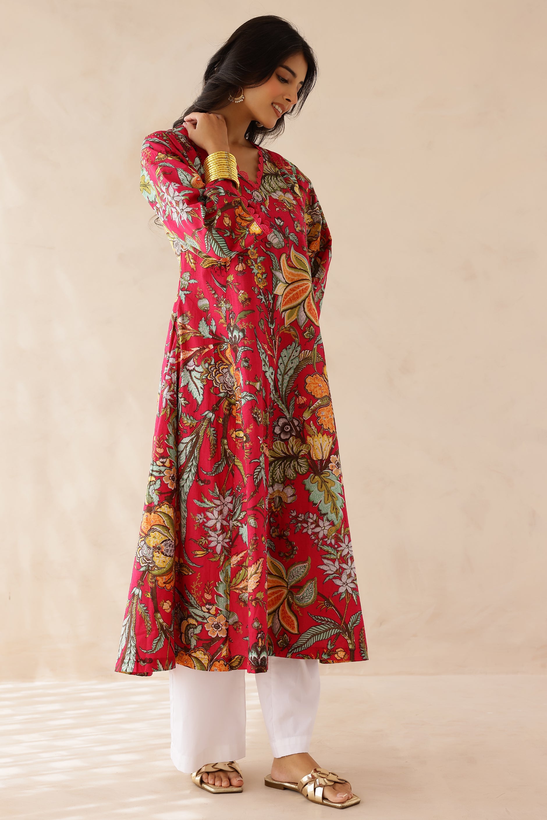 Woman wearing Multicolor Printed Cotton Kurta with Palazzo Set of 2 featuring all over multicolor prints, round to V neckline, 3/4th sleeves, and matching printed palazzo with elastic waist