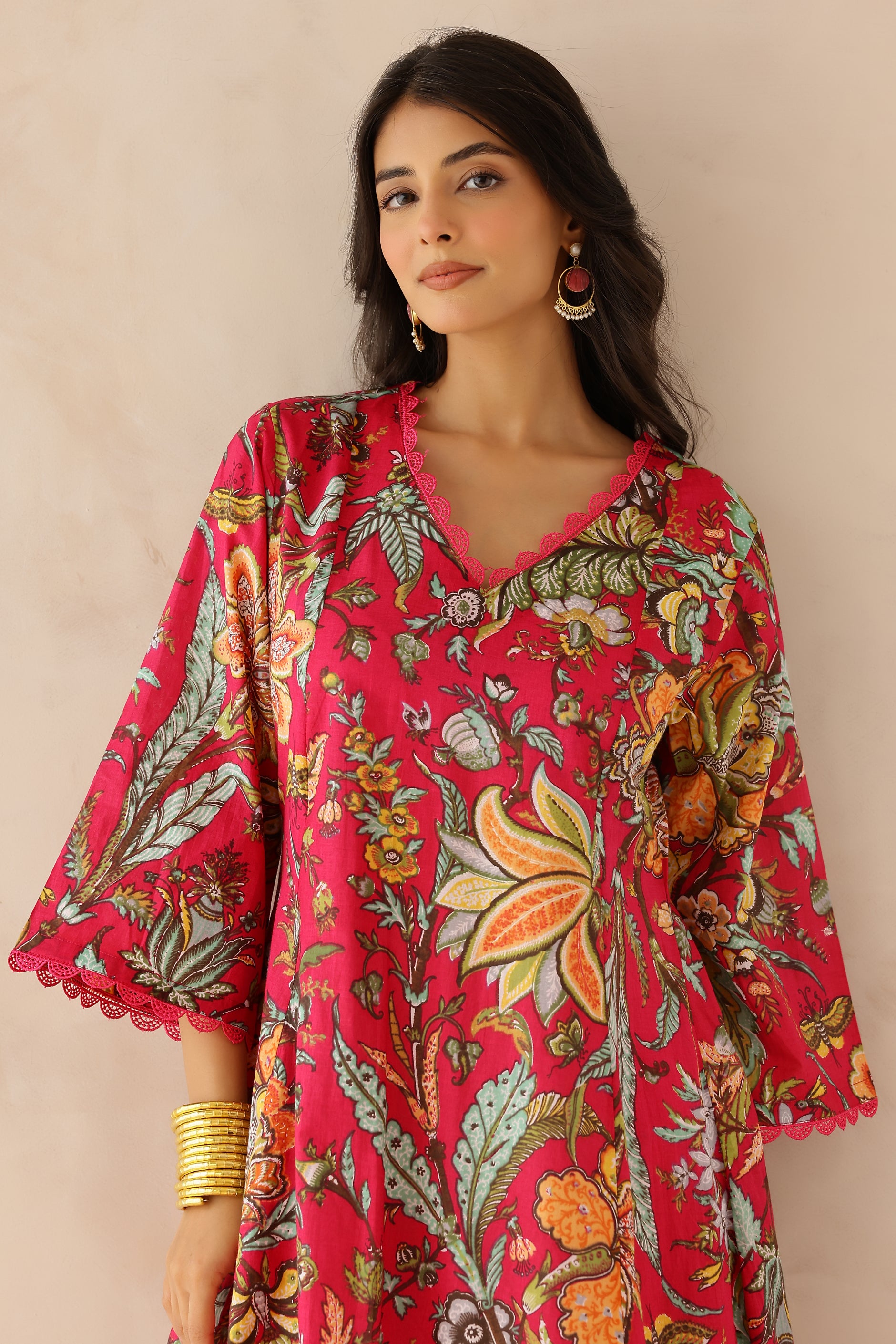 Woman wearing Multicolor Printed Cotton Kurta with Palazzo Set of 2 featuring all over multicolor prints, round to V neckline, 3/4th sleeves,