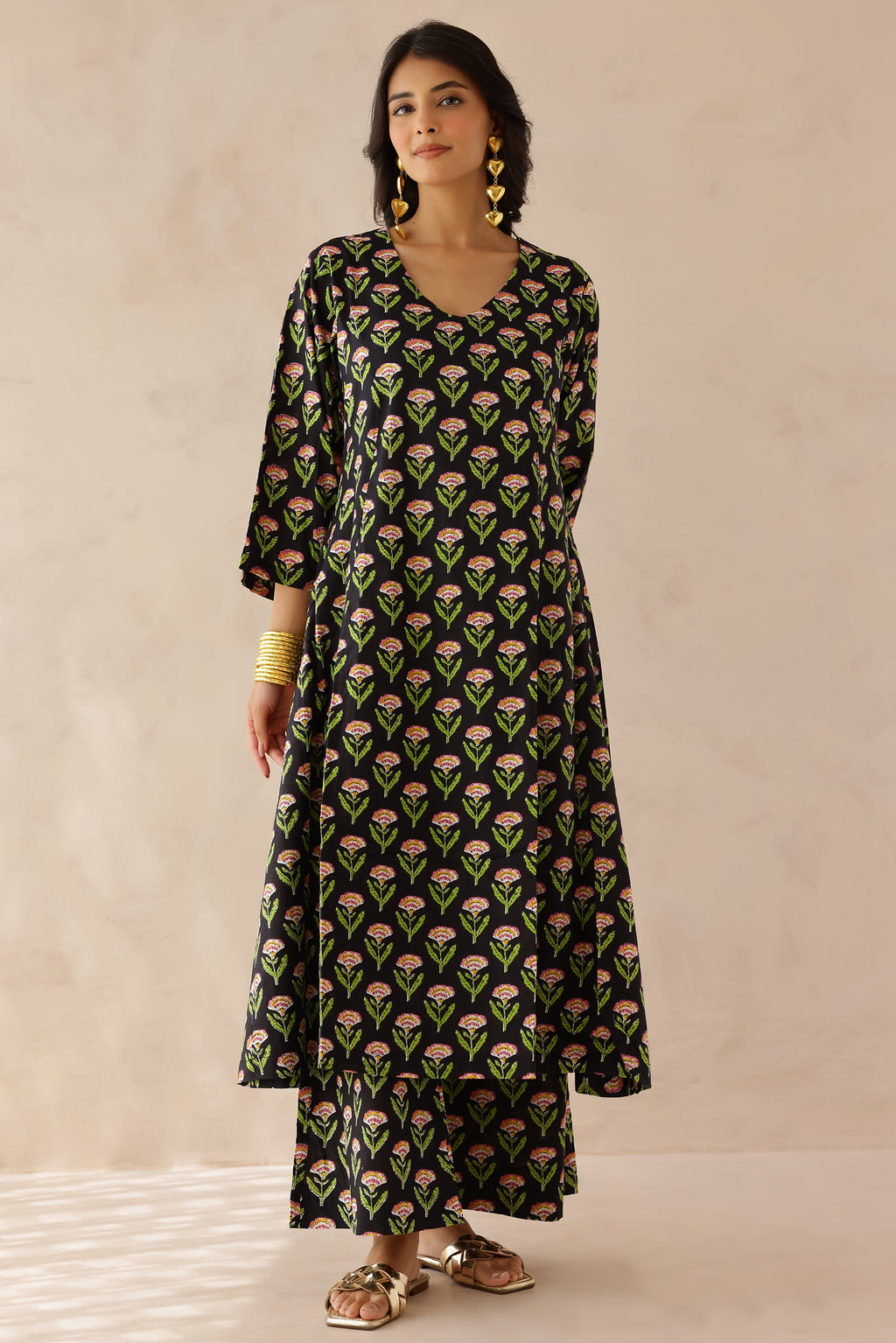 Black Printed Cotton Kurta with Palazzo Set of 2 for women featuring all over black and green prints, V neckline, 3/4th sleeves, and matching printed palazzo with elastic waist