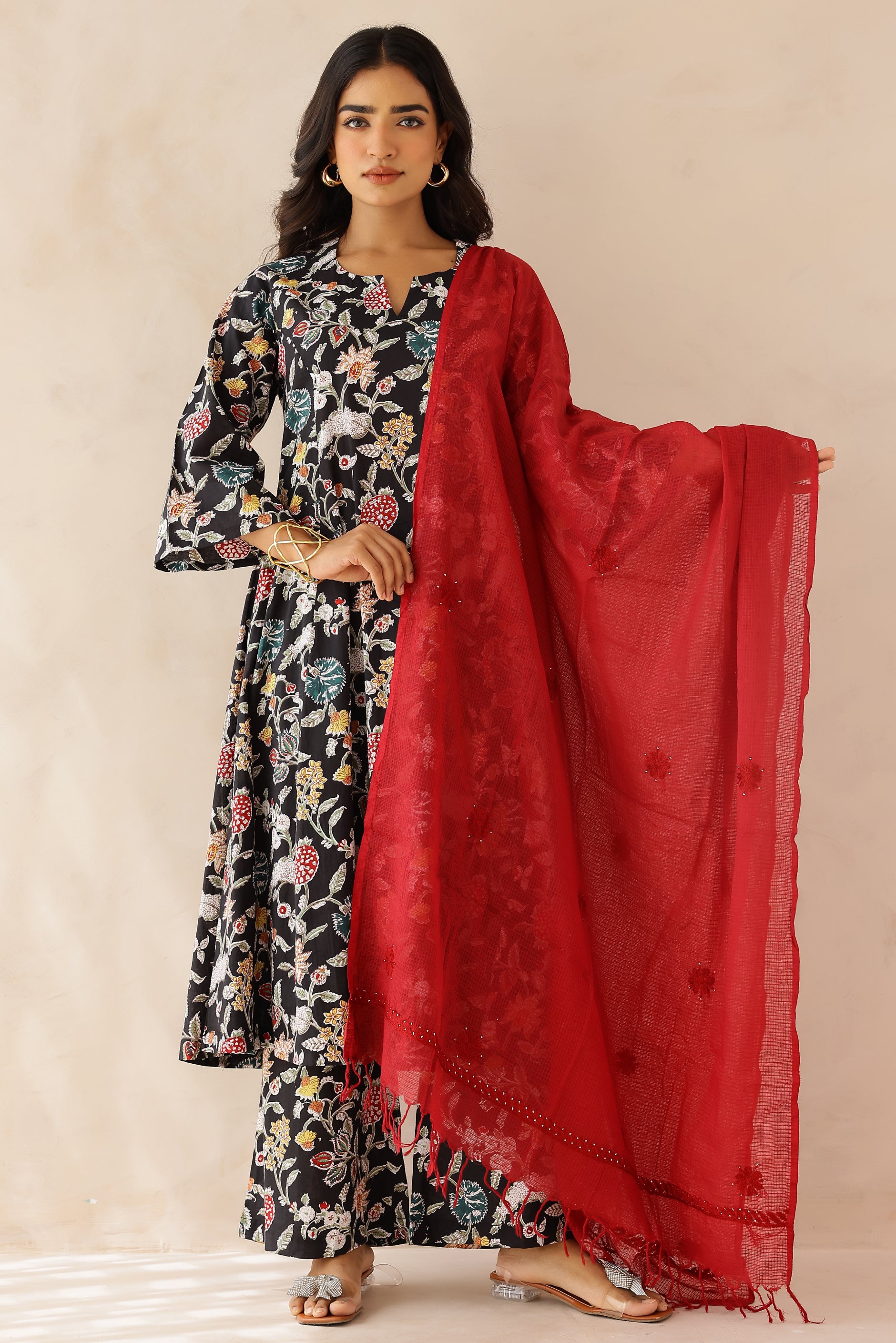 Woman wearing Black printed cotton kurta with round V-cut neckline, 3/4 sleeves, and cotton pants and dupatta