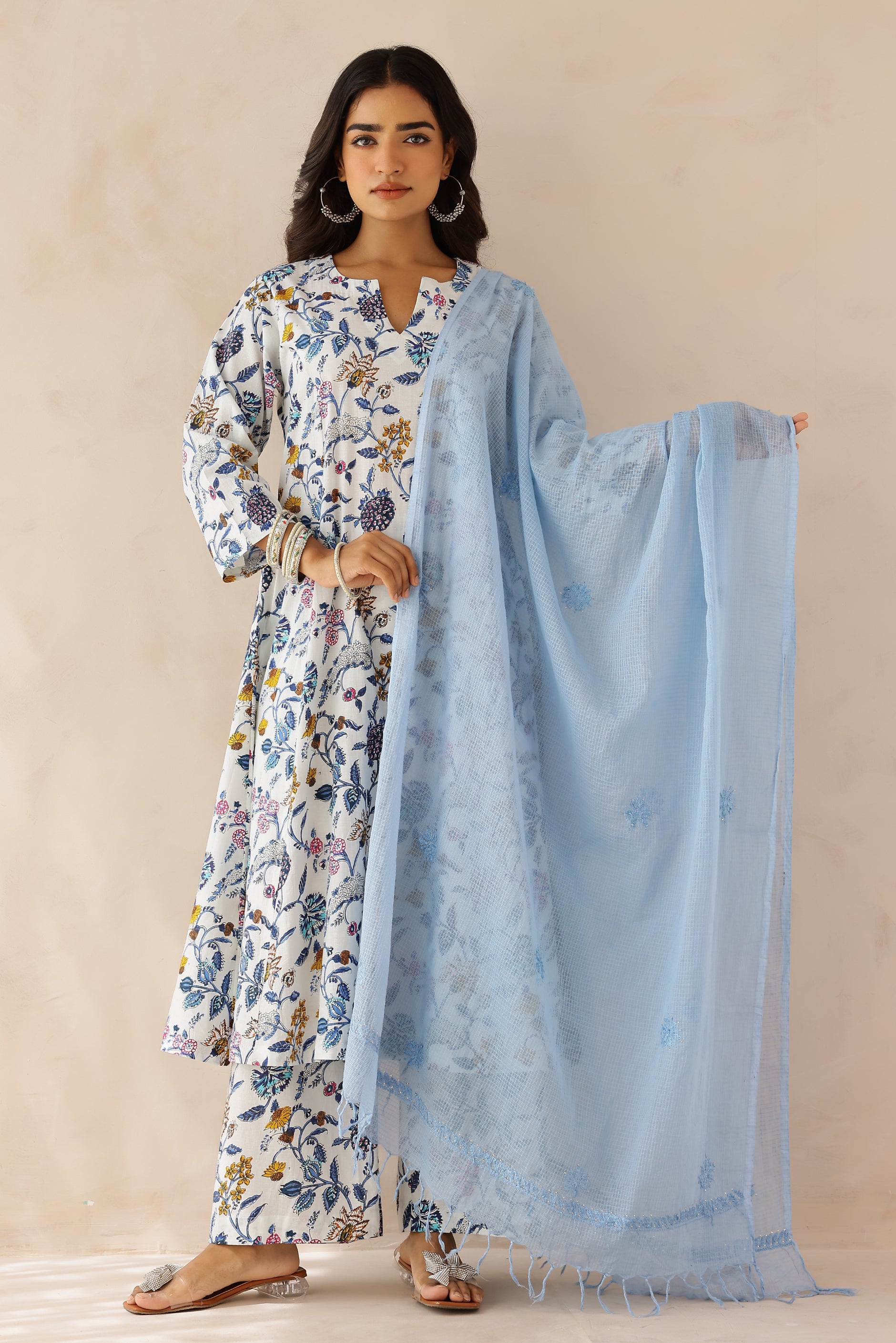 Woman wearing a floral kurta with a light blue dupatta 
