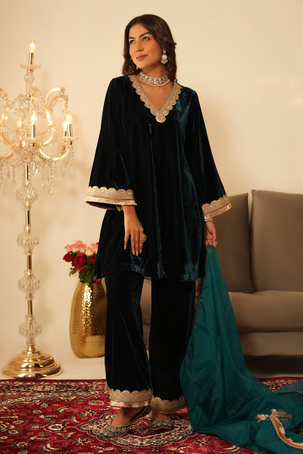 Woman in a  Blue Gota Lace Velvet Co-ord set which features Gota lace work detailing, a V-neckline, and Full sleeves. 