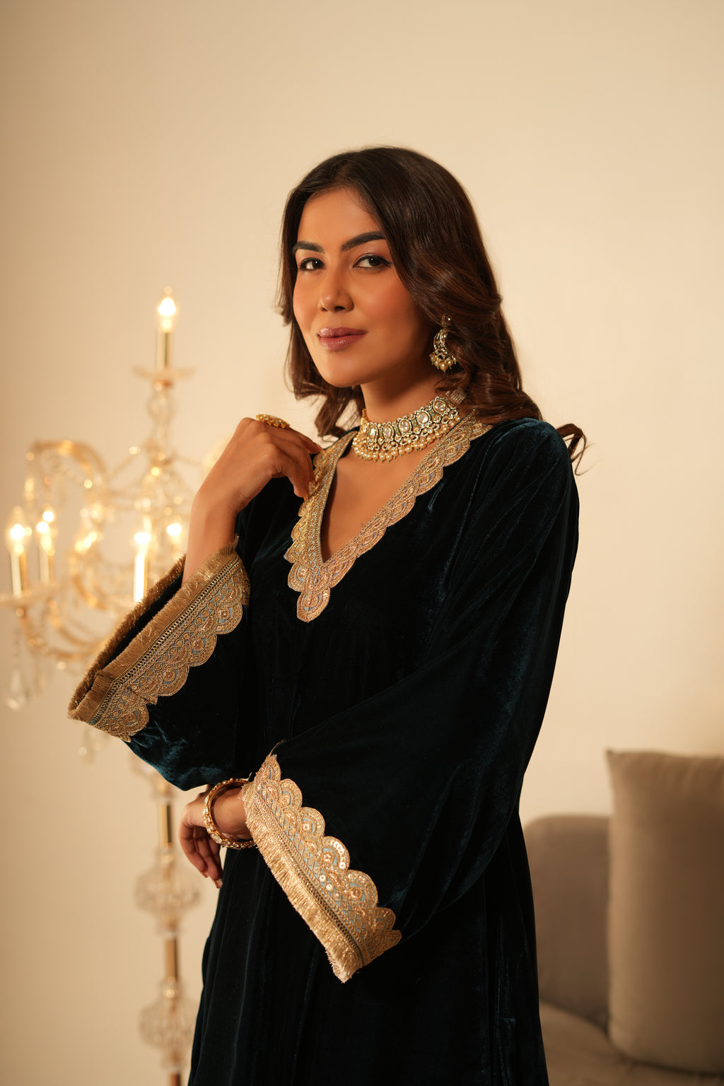 Woman in a  Blue Gota Lace Velvet Co-ord set which features Gota lace work detailing, a V-neckline, and Full sleeves. 